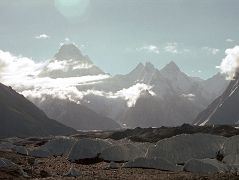 23 Gasherbrum IV, Gasherbrum II, Gasherbrum VII, Gasherbrum Twins, Gasherbrum V and Gasherbrum VI From Goro II When I looked ahead on the Baltoro Glacier, I could see the sun coming over the top of Gasherbrum IV (7925m) with Gasherbrum II peaking out to its right. After the col (6493m) the ridge rises to the Gasherbrum VII (6955m), the Gasherbrum Twins (6882m), Gasherbrum V (7147m) and further to the right Gasherbrum VI (7003m).